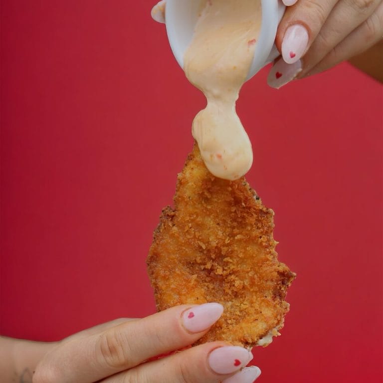 Sauce poured over a crumbed schnitzel
