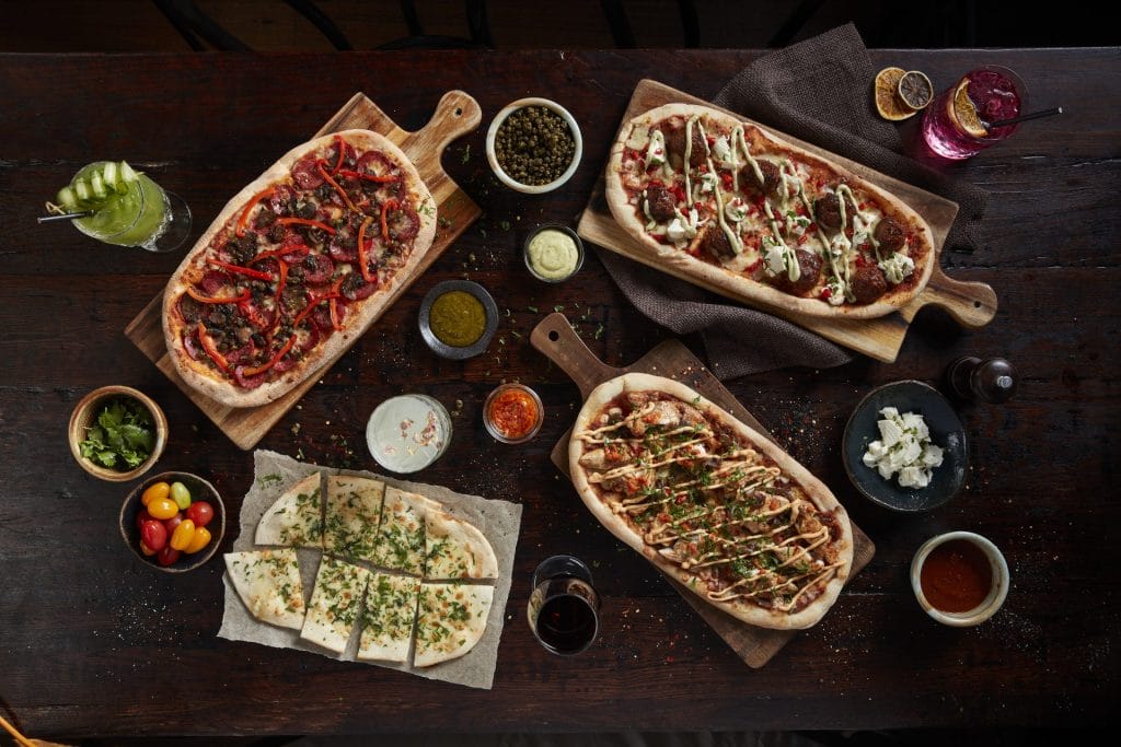 Pizzas made with Hercules pizza sauce and balsamic onions