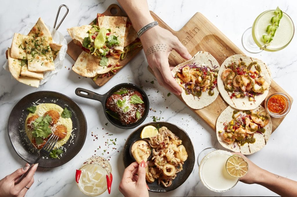 A table of share plates and tacos with Hercules sauces and aiolis